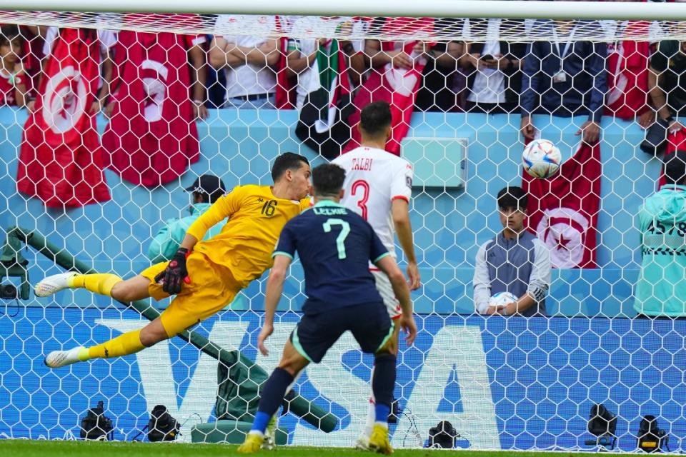 Tunisia's goalkeeper Aymen Dahmen fails to stop the ball as Australia's Mitchell Duke scores the opening goal of his team during the World Cup group D football match between Tunisia and Australia at the Al Janoub Stadium in Al Wakrah, Qatar, Saturday, Nov. 26, 2022. (AP Photo/Petr David Josek)