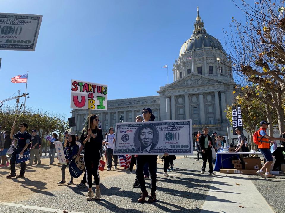 Marchers at a recent rally organized by Democratic presidential hopeful Andrew Yang parade around Civic Center Plaza in front of San Francisco's City Hall.