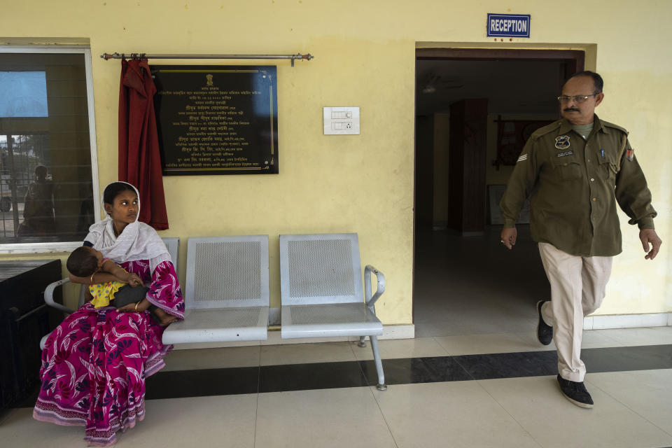 Nureja Khatun, 19, holding her 6 months old baby, sits outside a police station, in Morigaon district of Indian northeastern state of Assam, Saturday, Feb. 11, 2023. Khatun's husband Akbor Ali is one among more than 3,000 men, including Hindu and Muslim priests, who were arrested nearly two weeks ago in the northeastern state of Assam under a wide crackdown on illegal child marriages involving girls under the age of 18. (AP Photo/Anupam Nath)