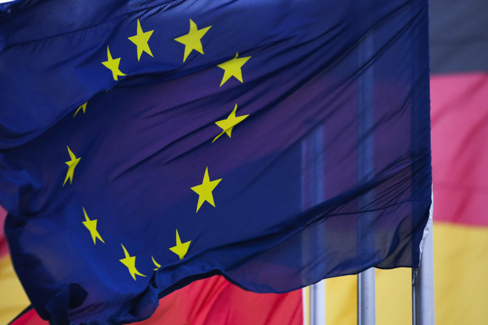 A European flag waves in front of German flags at the Reichstag building in Berlin, Germany, Thursday, Jan. 17, 2019 prior to a debate of the German parliament, Bundestag, about a law regulating the rights of British nationals during the Brexit transition period. (AP Photo/Markus Schreiber)