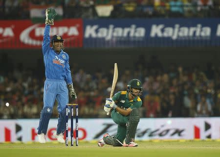 India's captain Mahendra Singh Dhoni (L) successfully appeals for the wicket of South Africa's JP Duminy during their second one-day international cricket match in Indore, India, October 14, 2015. REUTERS/Danish Siddiqui