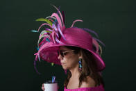 A race fan walks through the grounds of Churchill Downs before the 150th running of the Kentucky Derby horse race Saturday, May 4, 2024, in Louisville, Ky. (AP Photo/Charlie Riedel)