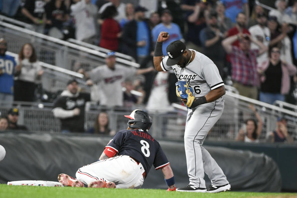 Chicago White Sox third baseman Hanser Alberto, right, celebrates after tagging out Minnesota Twins' Christian Vazquez at third base during the ninth inning of a baseball game, Tuesday, April 11, 2023, in Minneapolis. Twins won 4-3. (AP Photo/Craig Lassig)