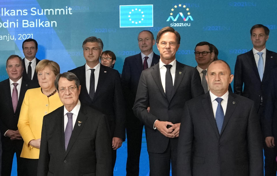 Cypriot President Nicos Anastasiades, front left, and Bulgaria's President Rumen Radev, front right, pose with other EU and Western Balkans leaders during a group photo at an EU summit at the Brdo Congress Center in Kranj, Slovenia, Wednesday, Oct. 6, 2021. European Union leaders are gathering Wednesday to reassure six countries in the Balkans region that they could join the trading bloc one day if they can meet its standards but are unlikely to give any signal even about when they might advance in their quests. (AP Photo/Petr David Josek)