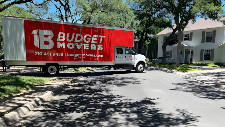 Budget Movers truck outside a home.