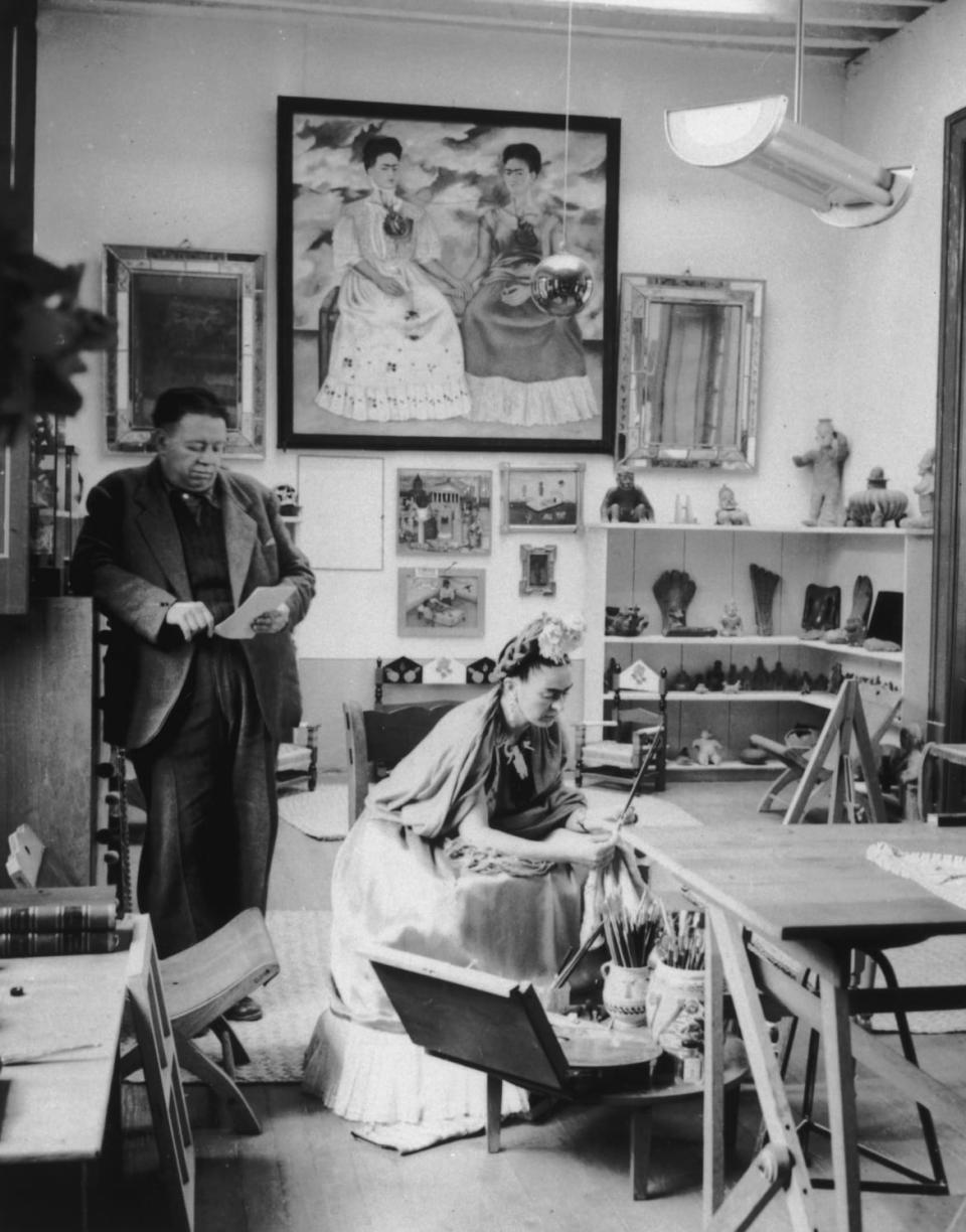 <div class="inline-image__caption"><p>Circa 1945, married Mexican artists Diego Rivera and Frida Kahlo read and work in a studio. Kahlo's self-portrait, 'The Two Fridas' (1939), hangs in the background with other works. </p></div> <div class="inline-image__credit">Hulton Archive/Getty Images</div>