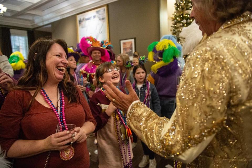 Partygoers greet royalty of different krewes at during a Twelfth Night Celebration at the Biloxi Welcome Center on Thursday, Jan. 5, 2023.