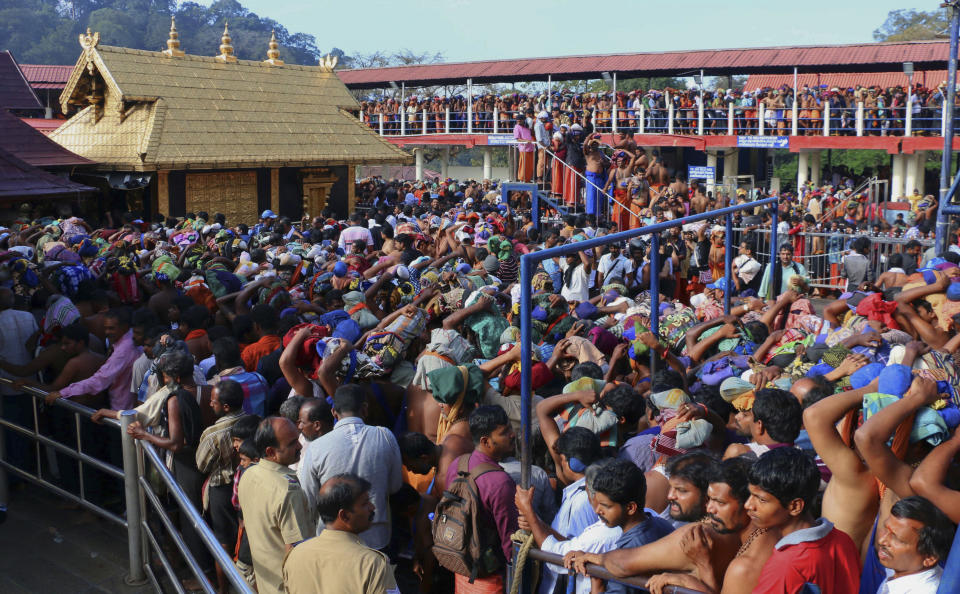 FILE - In this Dec. 1, 2015 file photo, Hindu worshippers stand in queues outside the Sabarimala temple, one of the world's largest Hindu pilgrimage sites, in the southern Indian state of Kerala. India's ruling party and the main opposition are both supporting a protest to keep females of menstruating age from entering the temple, in what some political observers say is a bid to shore up votes ahead of next year's general election. The country's Supreme Court had on Sept. 28, 2018, lifted the temple's ban on women of menstruating age, holding that equality is supreme irrespective of age and gender. (AP Photo/ Hareesh Kumar A S, File)