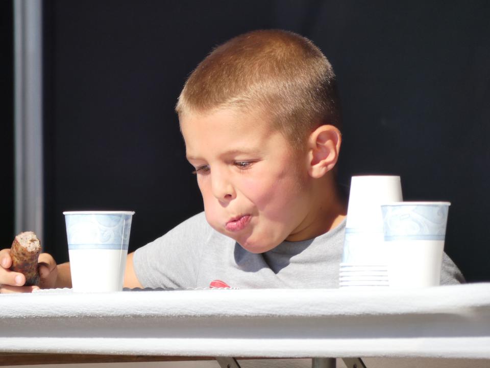 Nolan Bond, 6, competes in the bratwurst-eating contest on Thursday at the 2022 Bucyrus Bratwurst Festival. Nolan won in the 5-7 age group.