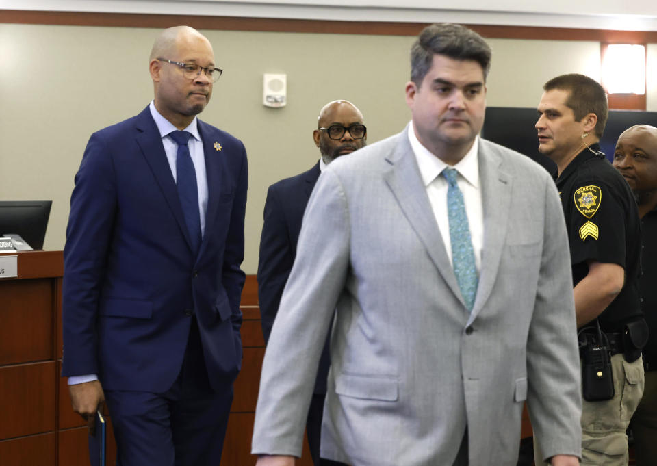 FILE - Nevada's Attorney General Aaron Ford, left, and Matthew Rashbrook, a special prosecutor, enter the courtroom where Nevada Republicans accused in a fake elector scheme are being arraigned on Dec. 18, 2023, in Las Vegas. A Nevada state court judge dismissed a criminal indictment, Friday, June 21, 2024, against six Republicans accused of submitting certificates to Congress falsely declaring Donald Trump the winner of the state’s 2020 presidential election. (Bizuayehu Tesfaye/Las Vegas Review-Journal via AP, File)