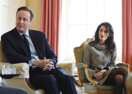 Lawyer Amal Clooney (R) sits with Britain's Prime Minister David Cameron and the former Maldives President Mohamed Nasheed (UNSEEN) in 10 Downing Street, in London, Britain 23 January 2016. REUTERS/Andy Rain/Pool