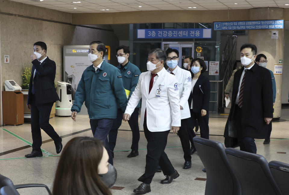 South Korean Prime Minister Han Duck-soo, second from left, arrives for a meeting with doctors at National Police Hospital in Seoul, South Korea, Wednesday, Feb. 21, 2024. South Korea on Wednesday officially ordered thousands of striking doctors to return to work immediately, a step that could lead to legal punishments if the doctors don't end their walkouts, which have caused numerous cancellations of surgeries and other treatments at hospitals. (Hwang Gang-mo/Yonhap via AP)