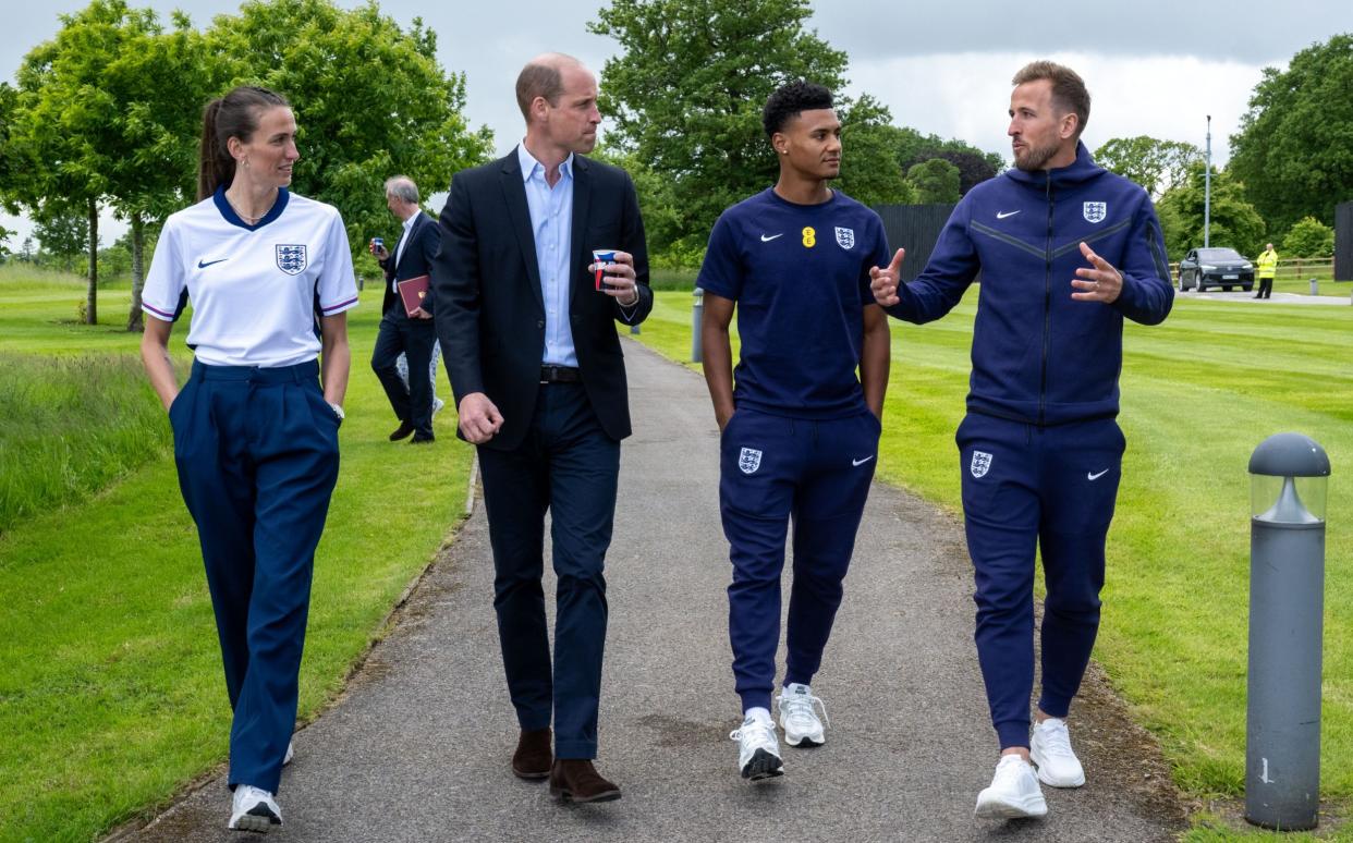 Prince William walks with Harry Kane (far right), Jill Scott and Ollie Watkins