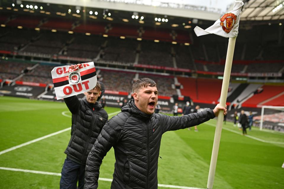 United supporters on the Old Trafford pitchAFP via Getty Images