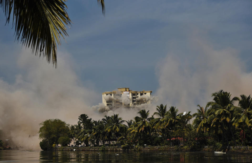 Alpha Serene, a water-front residential apartment, is razed to the ground by controlled implosion in Kochi, India, Saturday, Jan. 11. 2020. Authorities in southern Kerala state on Saturday razed down two high-rise luxury apartments using controlled implosion in one of the largest demolition drives in India involving residential complexes for violating environmental norms. (AP Photo/R S Iyer)