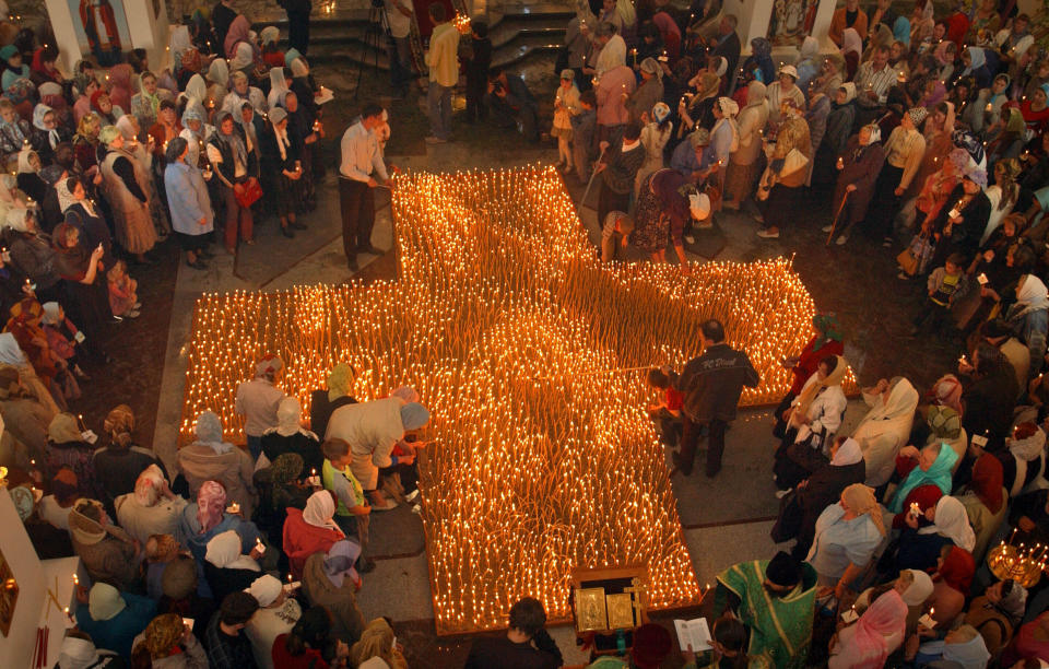 FILE - People light candles during an anti-abortion service in an Orthodox church in Vladivostok, in Russia's Far East, Thursday, May 31, 2007. Although abortion in Russia is still legal and widely available, new restrictions are being considered as President Vladimir Putin takes an increasingly socially conservative turn and seeks to reverse the country's declining population. (AP Photo, File)