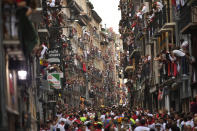 <p>Revellers wait for fighting bulls from the Victoriano del Rio ranch during the 6th day of the running of the bulls at the San Fermin Festival in Pamplona, northern Spain, July 12, 2018. (Photo: Alvaro Barrientos/AP) </p>