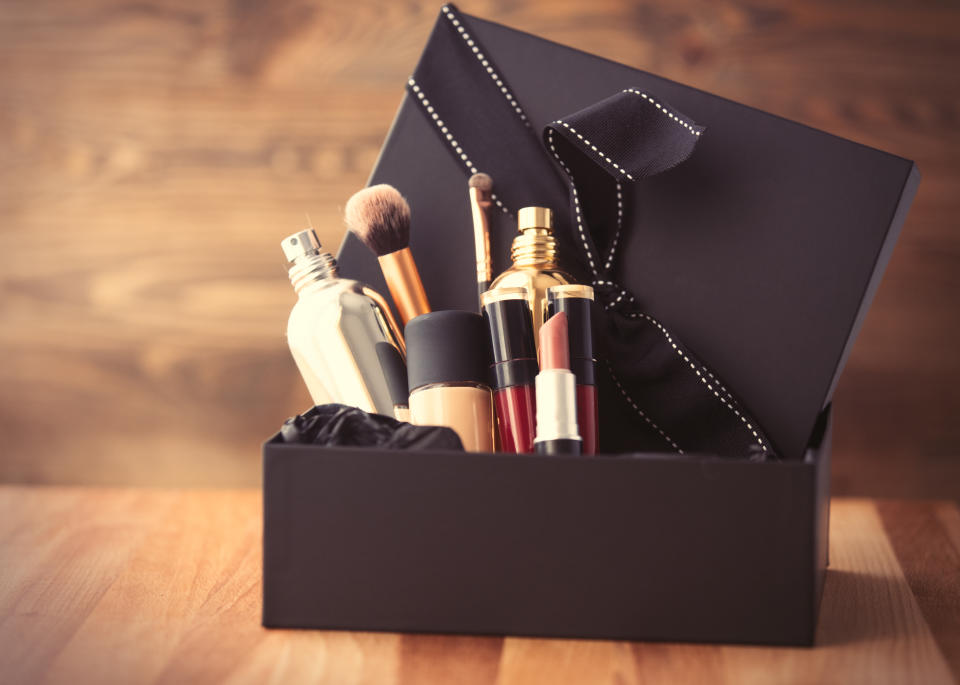 Vintage cosmetic bottles in gift box on wooden background