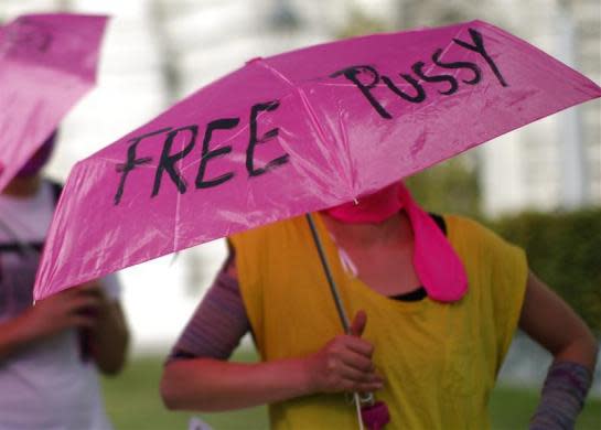 A supporter of the Russian feminist punk band Pussy Riot holds an umbrella as she attends a gathering in Vienna, August 17, 2012.