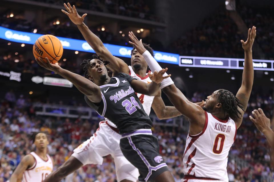 Kansas State forward Arthur Kaluma (24) tries to shoot around Iowa State defender Tre King (0) during their Big 12 Tournament quarterfinal game Thursday night at T-Mobile Center.