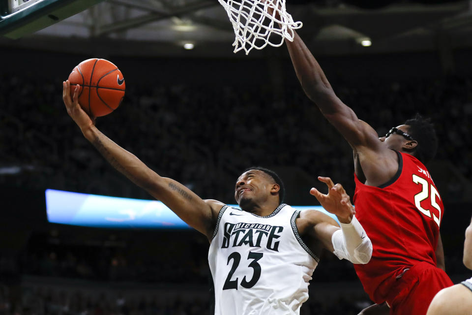 Michigan State forward Xavier Tillman (23) drives on Maryland forward Jalen Smith (25) in the second half of an NCAA college basketball game in East Lansing, Mich., Saturday, Feb. 15, 2020. (AP Photo/Paul Sancya)