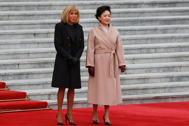 French First Lady Brigitte Macron and Chinese First Lady Peng Liyuan attend a welcome ceremony outside the Great Hall of the People in Beijing