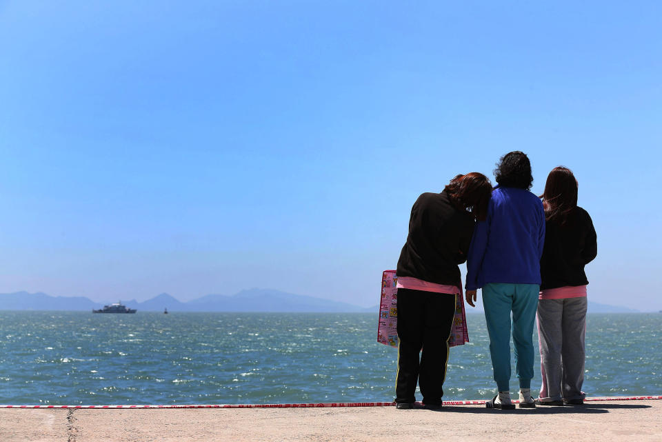 Relatives of a passenger aboard the sunken Sewol ferry look toward the sea at a port in Jindo, South Korea, Wednesday, April 30, 2014. South Korea's president apologized Tuesday for the government's inept initial response to a deadly ferry sinking as divers fought strong currents in their search for nearly 100 passengers still missing nearly two weeks after the accident.(AP Photo/Yonhap) KOREA OUT