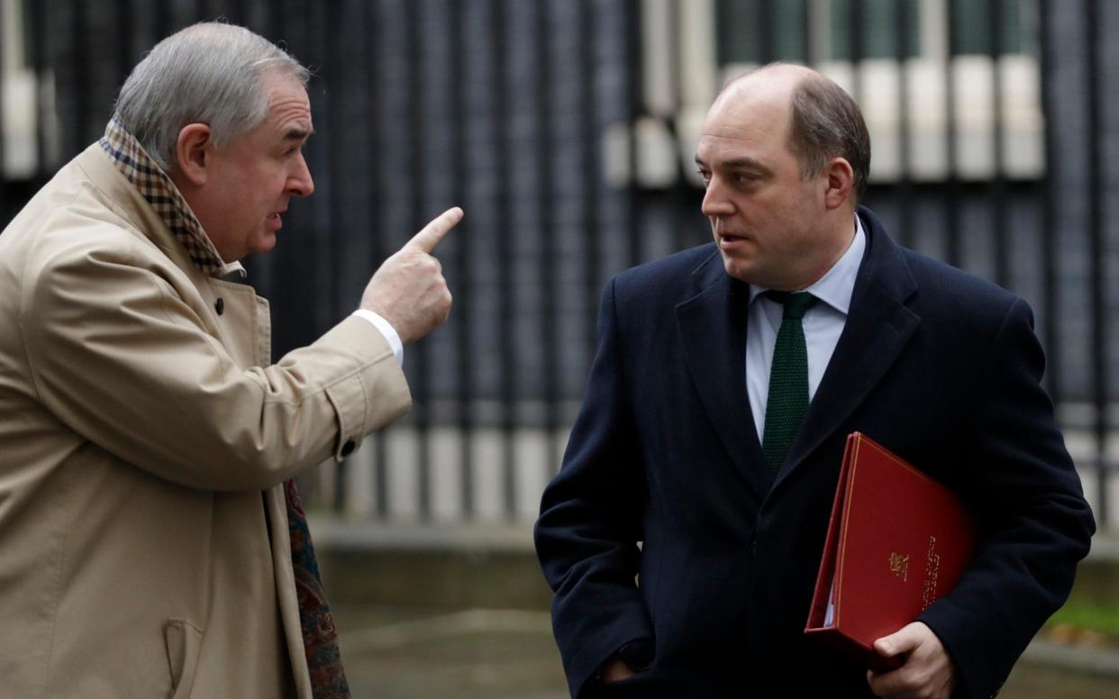 Britain's Attorney General Geoffrey Cox (l) chats with Defence Secretary Ben Wallace as they leave 10 Downing Street after the first cabinet meeting since the general election. Dec. 17, 2019. - AP