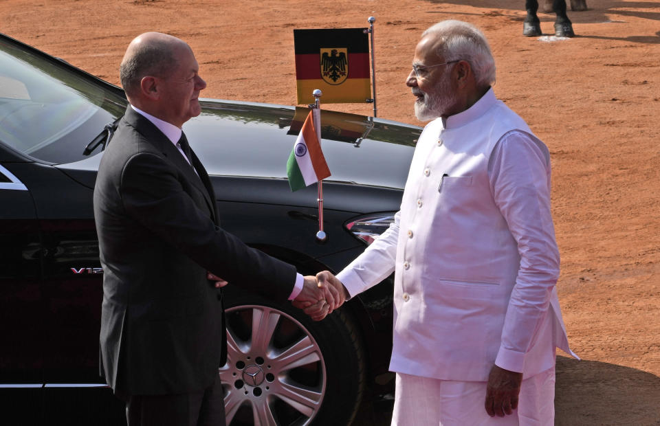 Indian Prime Minister Narendra Modi welcomes German Chancellor Olaf Scholz, during latter's ceremonial reception at the Indian presidential palace, in New Delhi, India, Saturday, Feb. 25, 2023. (AP Photo/Manish Swarup)