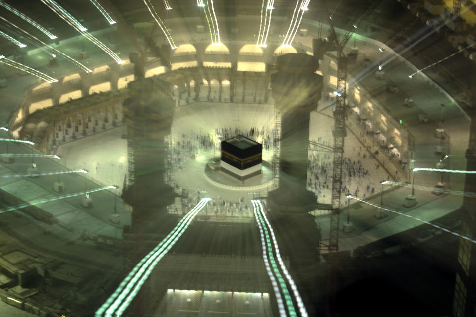 In this photo taken with low shutter speed, Muslim pilgrims circumambulate the Kaaba, the cubic building at the Grand Mosque, at the start the annual hajj pilgrimage, Sunday, July 18, 2021. The pilgrimage to Mecca required once in a lifetime of every Muslim who can afford it and is physically able to make it, used to draw more than 2 million people. But for a second straight year it has been curtailed due to the coronavirus with only vaccinated people in Saudi Arabia able to participate. (AP Photo/Amr Nabil)