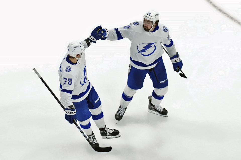 Tampa Bay Lightning's Nicholas Paul (20) celebrates with Emil Martinsen Lilleberg (78) after scoring goal against the Toronto Maple Leafs during third period of an NHL hockey game in Toronto, Ontario, Wednesday, April 3, 2024. (Chris Young/The Canadian Press via AP)