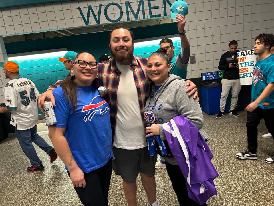 Isaacs, centre, posted this picture to Facebook on Jan. 7 showing him at a game between the Miami Dolphins and his favourite team, the Buffalo Bills.