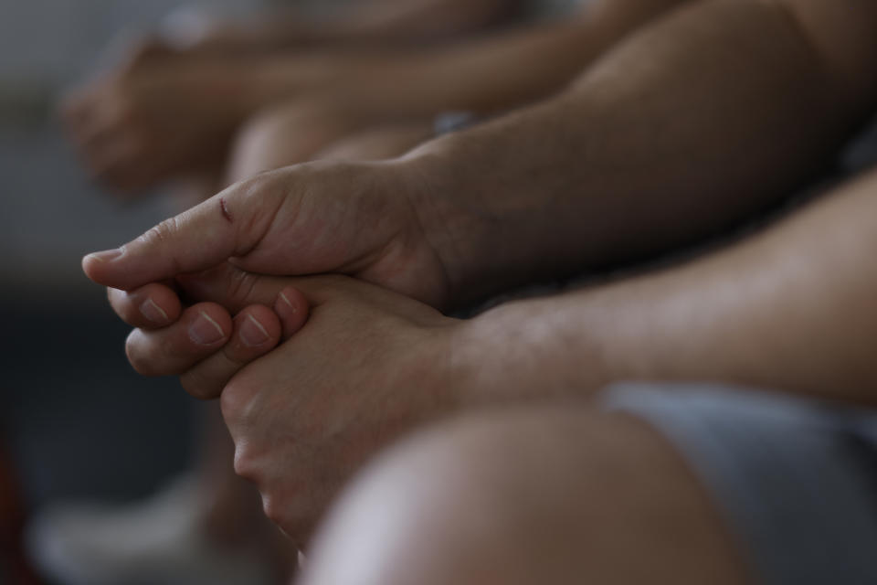 The hands of two refugees from Syria, who came to Europe from Belarus border, as they give an Interview to the Associated Press in Berlin, Germany, Monday, June 27, 2022. One of them left Syria late last year, he read on social media that the easiest way to cross into the European Union was to fly to Belarus and then walk across the border to Poland. (AP Photo/Michele Tantussi)