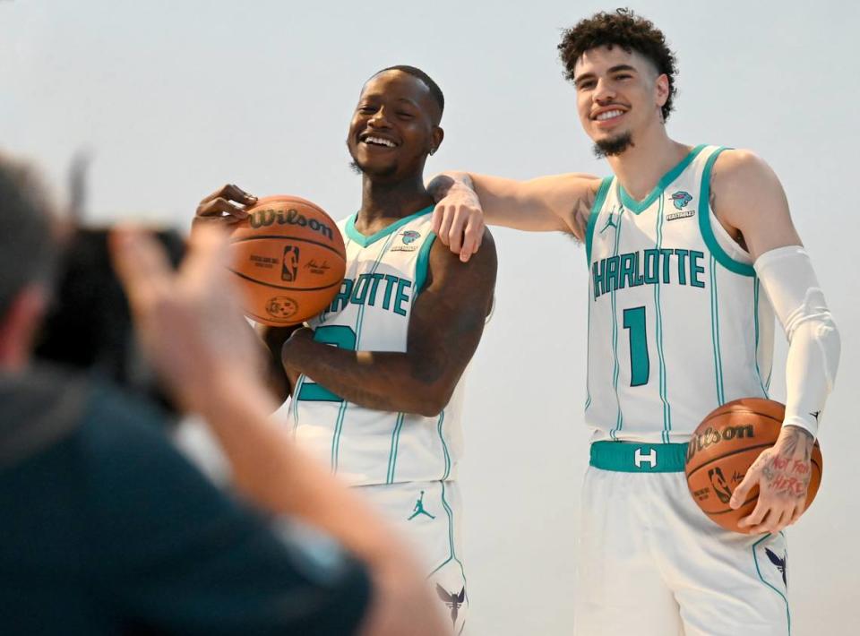 NBAE photographer Kent Smith, left, photographs Charlotte Hornets guards Terry Rozier, left and LaMelo Ball, right, during the team’s media day on Monday, October 2, 2023 at Spectrum Center in Charlotte, NC. JEFF SINER/jsiner@charlotteobserver.com