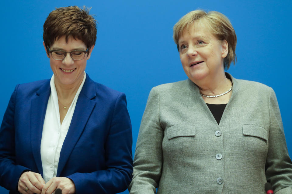 German Chancellor Angela Merkel, right, and CDU party chairwoman and Defense Minister Annegret Kramp-Karrenbauer, left, attend a party's board meeting at the headquarters in Berlin, Germany, Monday, Feb. 10, 2020. Angela Merkel's designated successor Annegret Kramp-Karrenbauer will quit her role as head of the Germany's strongest party in summer and won't stand for the chancellorship.(AP Photo/Markus Schreiber)