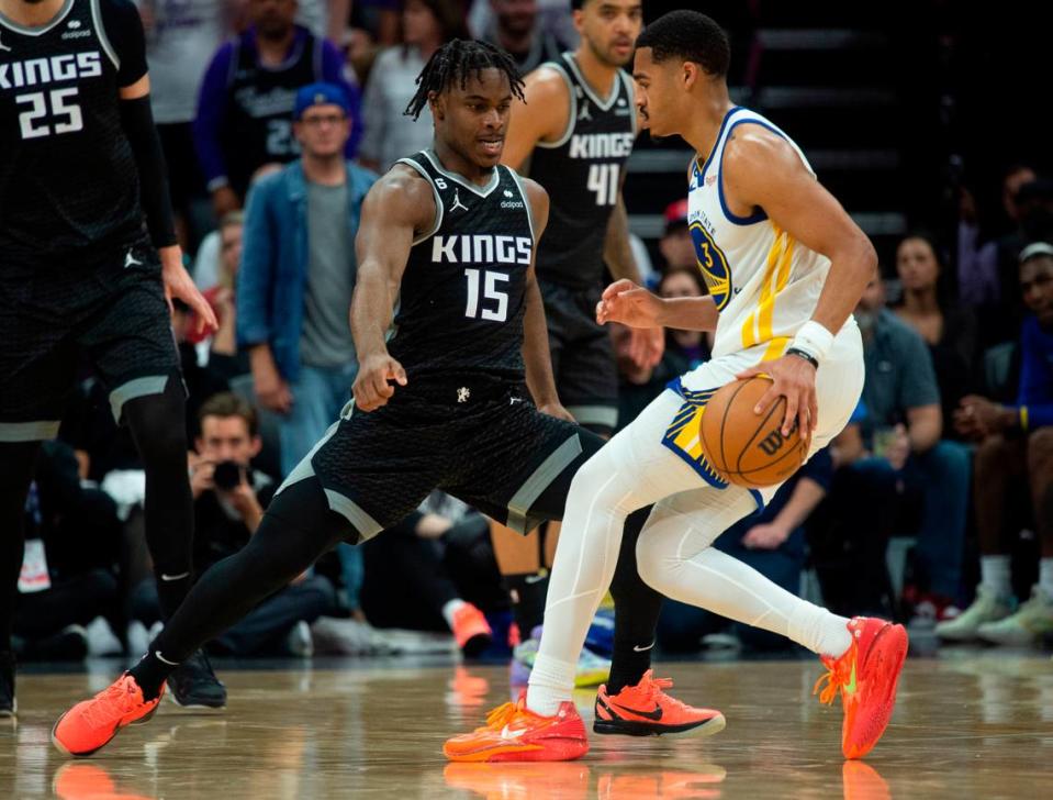 Sacramento Kings guard Davion Mitchell (15) defends against Golden State Warriors guard Jordan Poole (3) during Game 1 of the first-round NBA playoff series at Golden 1 Center on Saturday, April 15, 2023.