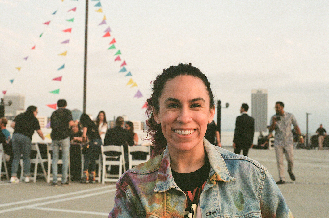 Nicole Garcia, in an outdoor setting, smiles at the camera.