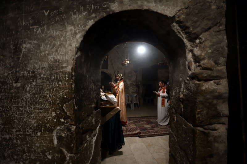 Worshippers pray inside the Syrian Orthodox section of the Church of the Holy Sepulchre, revered as the site of Jesus's crucifixion and burial, in Jerusalem's Old City