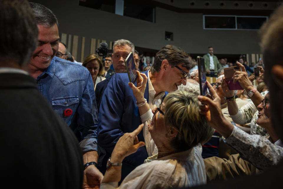 Spanish Prime Minister Pedro Sánchez and socialist candidate, Salvador Illa, center, greet supporters during a campaign rally in Villanova i la Gertru, near Barcelona, Spain, Thursday, May 9, 2024. Some nearly 6 million Catalans are called to cast ballots in regional elections on Sunday that will surely have reverberations in Spain's national politics. (AP Photo/Emilio Morenatti)