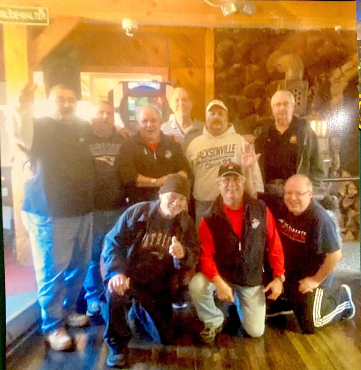 Ken Lewis is pictured at top right with his poker buddies on Veterans Day 2020, a month before his death.