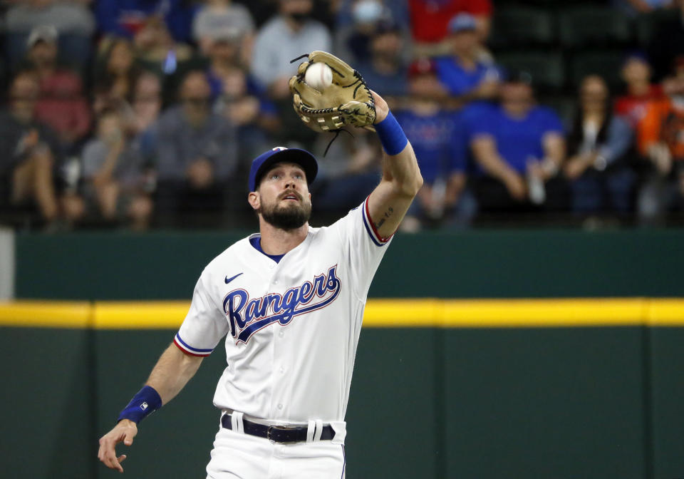 Texas Rangers left fielder David Dahl makes the catch of a fly ball during the first inning of a baseball game in Arlington, Texas, Saturday, April 17, 2021. (AP Photo/Ray Carlin)