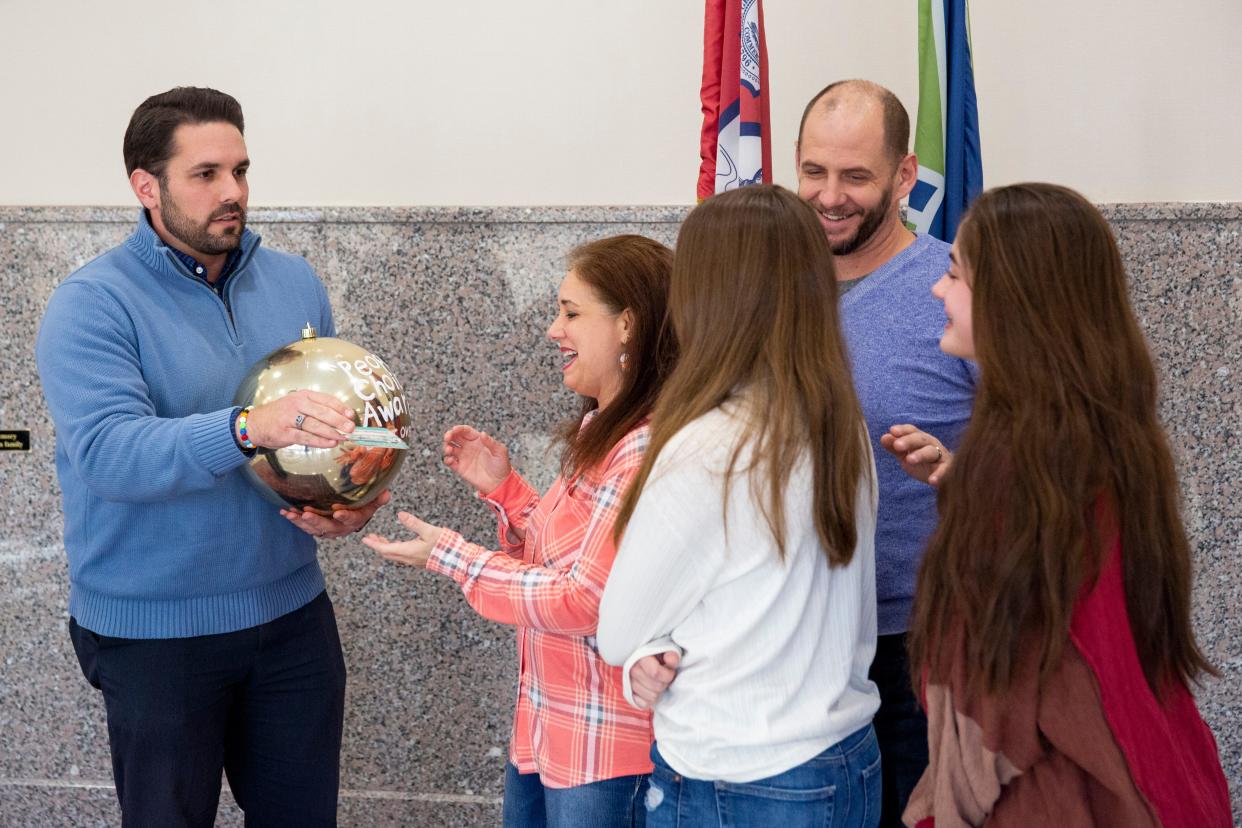 Mayor Scott Conger presents Jennifer Miller, Elliana Miller, Andrew Miller and Sonora Miller with the “Best in Snow” award for best overall display in the Light Up Jackson contest on Monday, January 9, 2023, at city hall in Jackson, Tenn. 