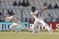 Cricket - India v New Zealand - Second Test cricket match - Eden Gardens, Kolkata, India - 30/09/2016. IWriddhiman Saha (R) plays a shot past New Zealand's wicketkeeper Bradley-John Watling. REUTERS/Rupak De Chowdhuri