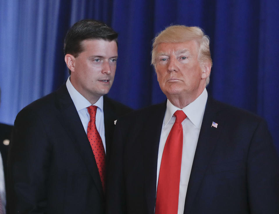 In this Aug. 12, 2017, photo, Rob Porter, left, White House Staff Secretary, speaks to President Donald Trump after Trump made remarks regarding the ongoing situation in Charlottesville, Va., at Trump National Golf Club in Bedminister, N.J. The White House has instructed Porter and another former aide to President Donald Trump not to appear at a House Judiciary Committee hearing Tuesday, Sept. 17, 2019, saying Porter and Rick Dearborn are "absolutely immune" from testifying at what the panel is calling its first impeachment hearing. (AP Photo/Pablo Martinez Monsivais)