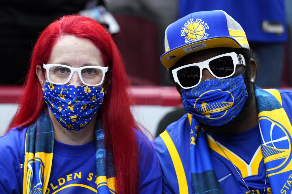 Fans wait for an NBA basketball game between the Golden State Warriors and the Chicago Bulls in Chicago, Friday, Jan. 14, 2022. (AP Photo/Nam Y. Huh)