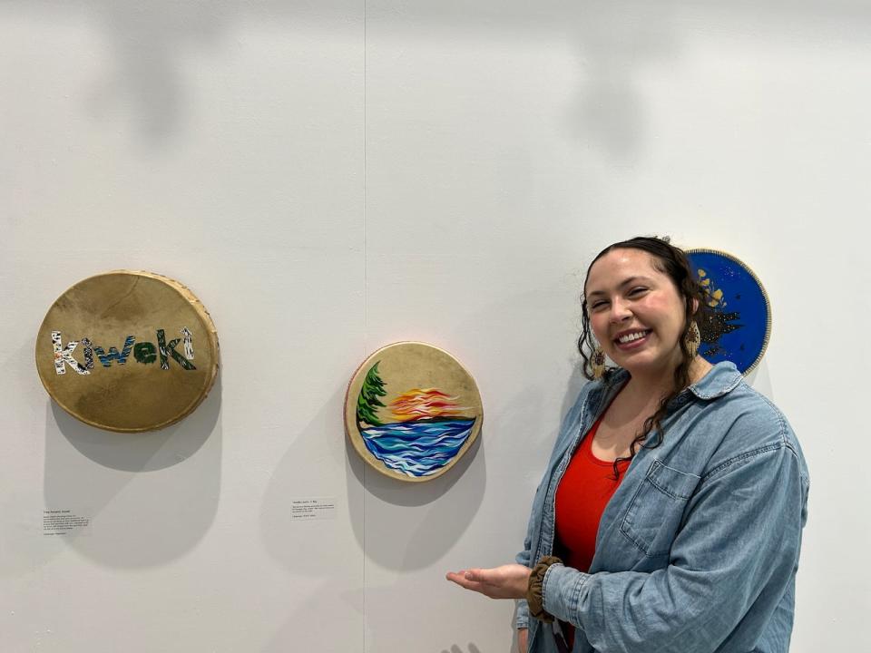 Artist Natalie Laurin with her drum 'G Bay' (middle drum) is connected to the Michif language. The ceinture fléchée surrounds the lively waters of Georgian Bay, where she feels most at home and connected to her roots.