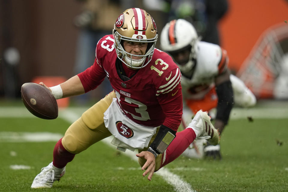 San Francisco 49ers quarterback Brock Purdy (13) scrambles away from Cleveland Browns linebacker Jeremiah Owusu-Koramoah during the second half of an NFL football game Sunday, Oct. 15, 2023, in Cleveland. (AP Photo/Sue Ogrocki)