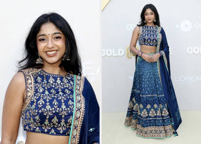 Woman in traditional embellished blue lehenga with cropped blouse, posing at an event