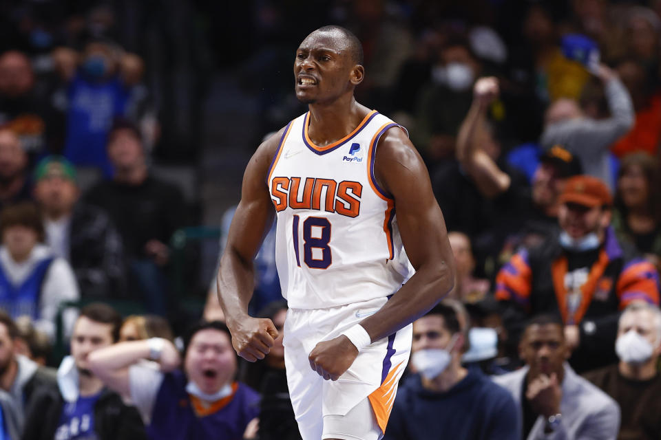 Phoenix Suns forward Bismack Biyombo celebrates after dunking during the second half of an NBA basketball game against the Dallas Mavericks, Thursday, Jan. 20, 2022, in Dallas. (AP Photo/Brandon Wade)