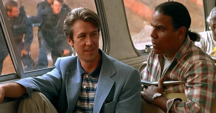 Two men talk on a bus in Speed.